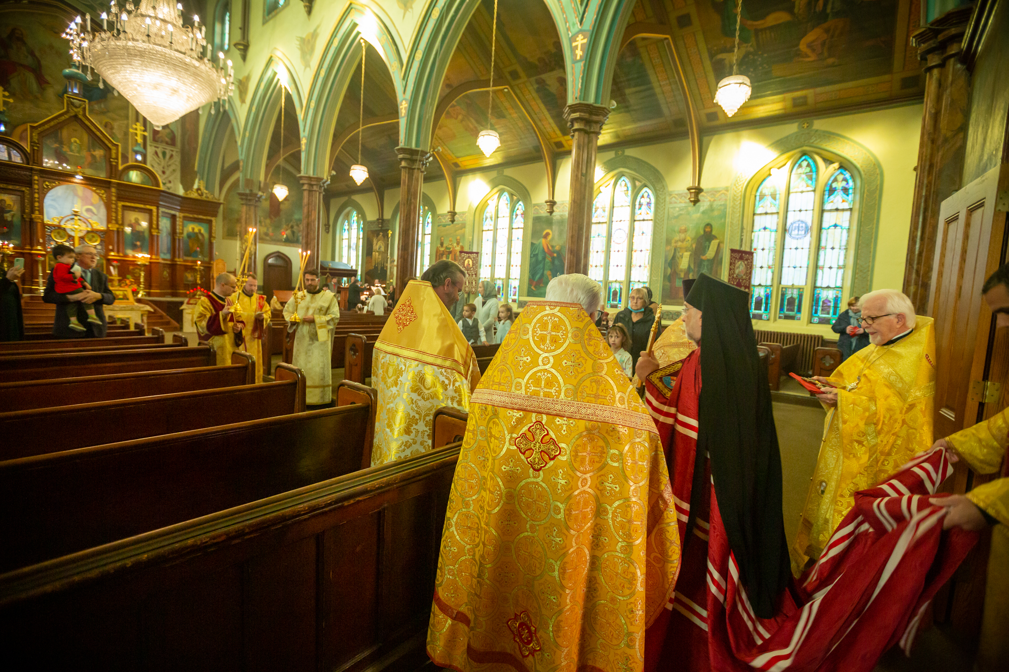 Clergy in gold vestments processing through the nave