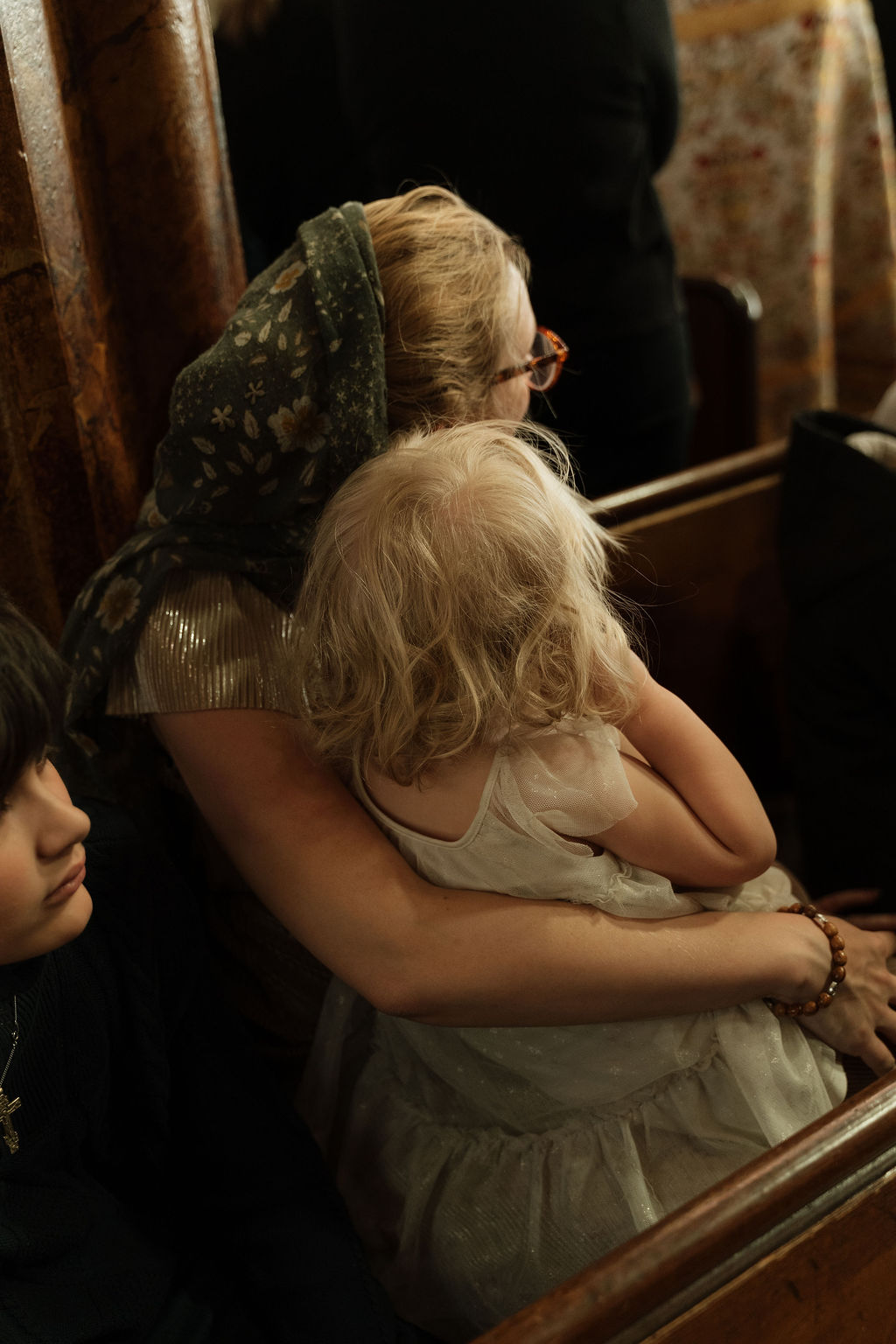 A mother and child at prayer in the pews