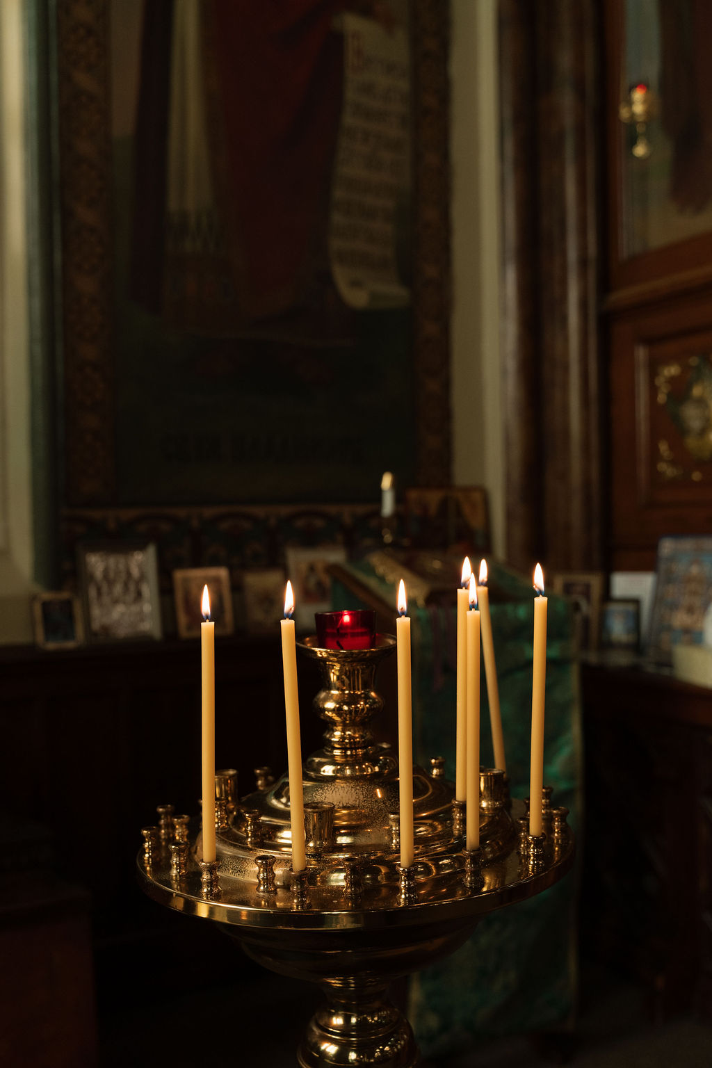 Votive candles burning before the icons